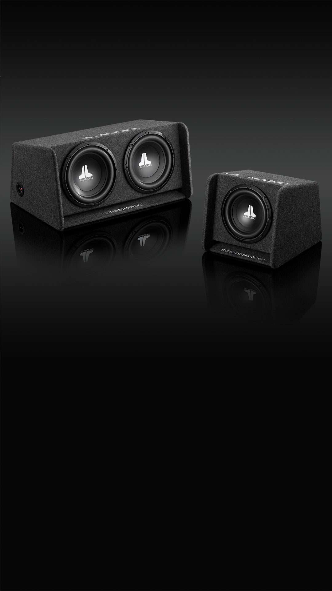 A pair of BassWedge Enclosed Subwoofers in a dark sleek setting.