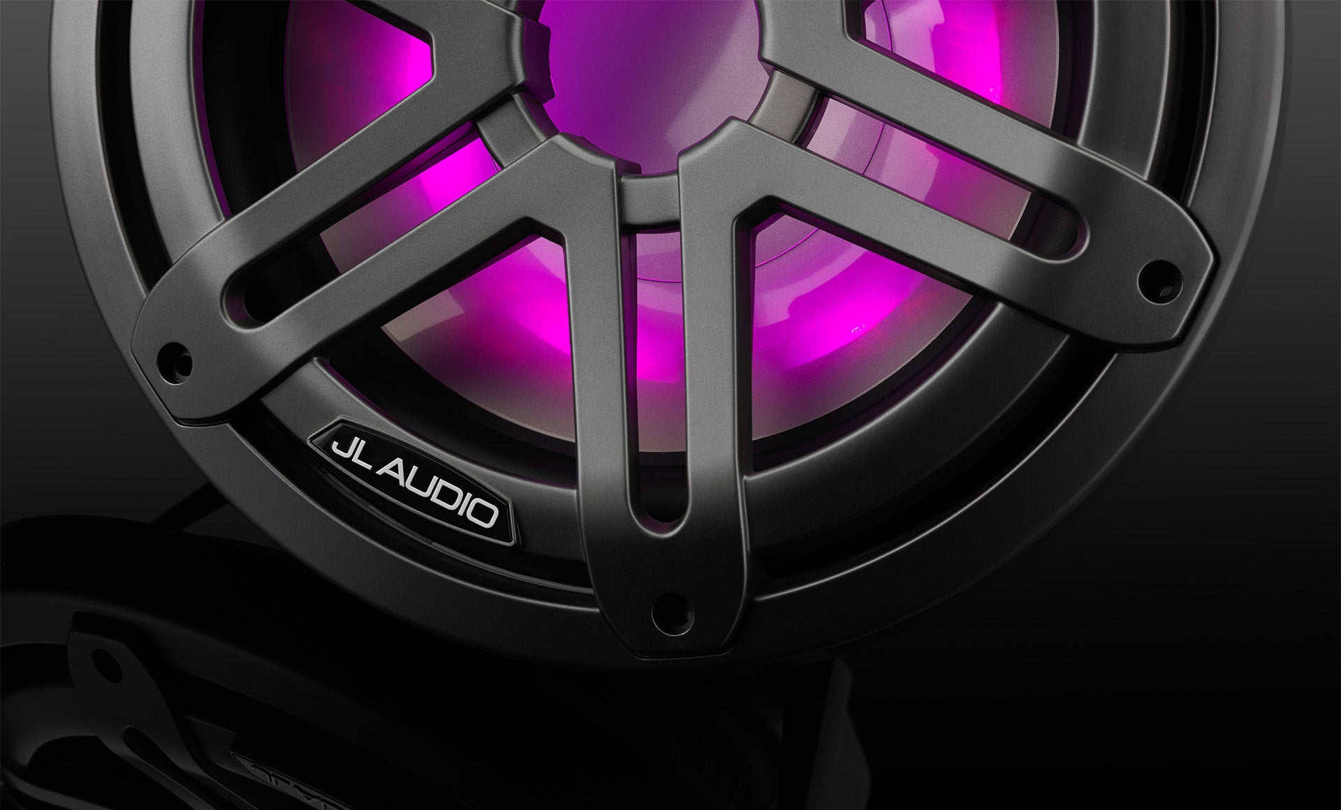 A M3 10 inch marine subwoofer unit with pink RGB LED lights in a dark sleek setting.