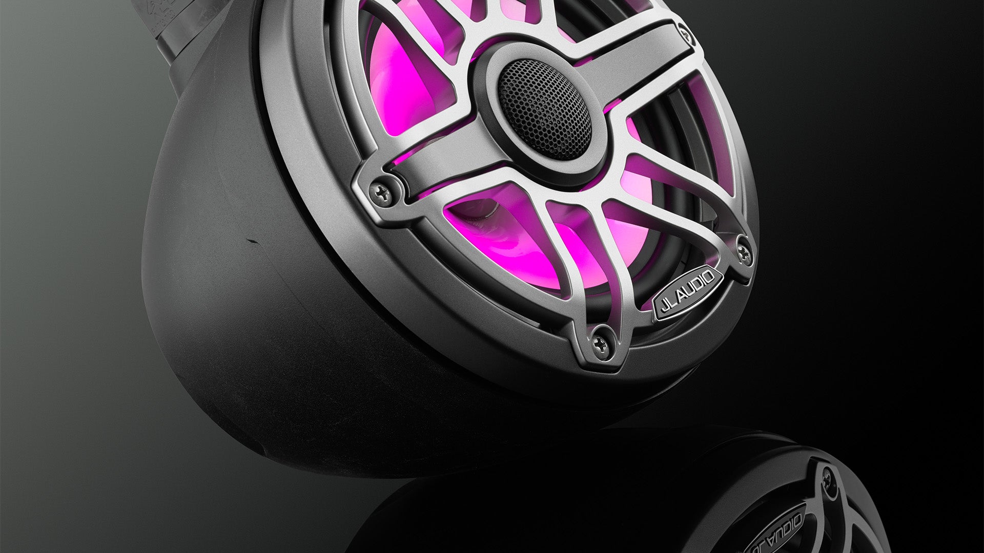 M6 VeX audio unit with pink colored Transflective™ LED technology in a dark sleek setting.