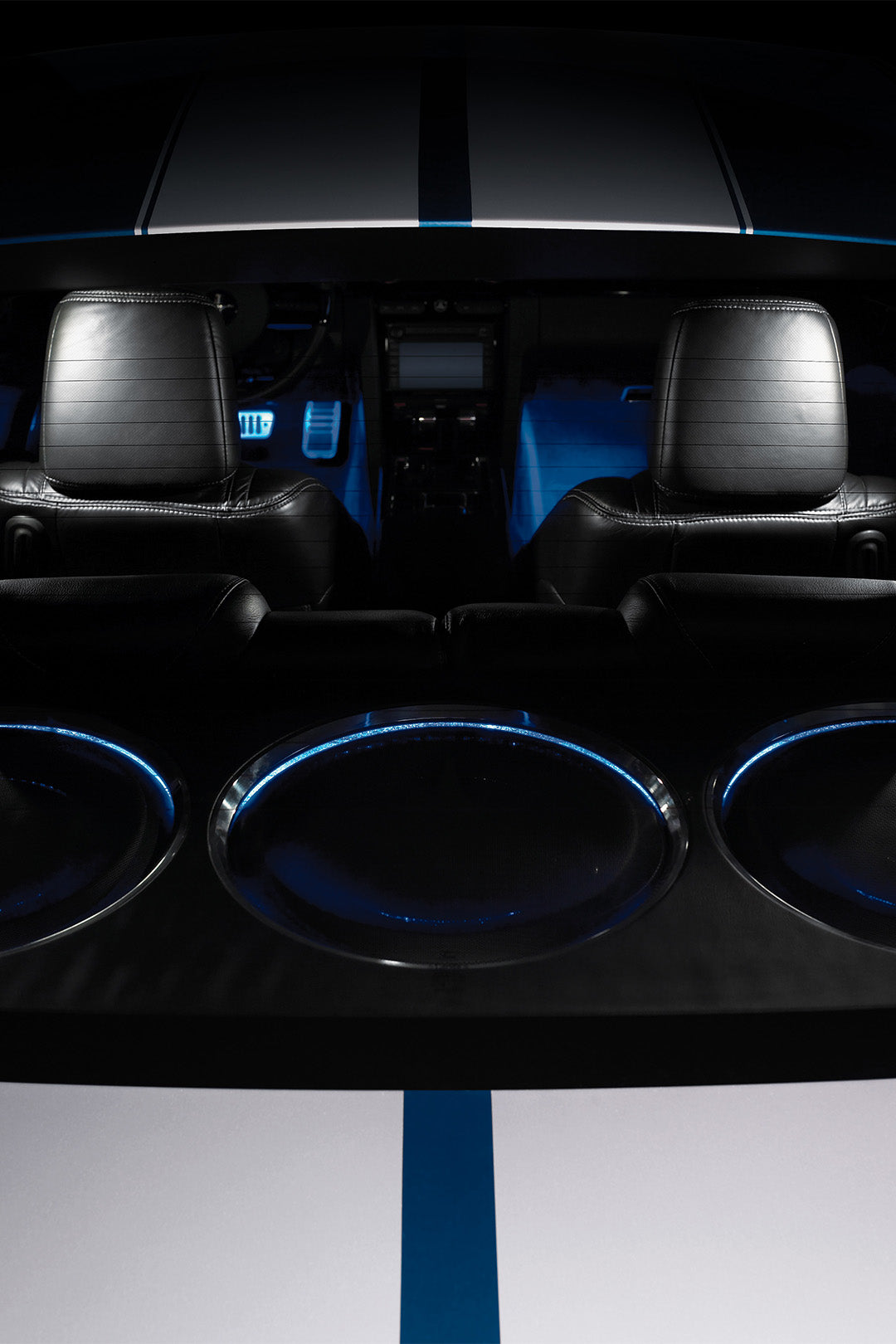 A series of 3 TW5v2 car audio subwoofer units installed in the back of a vehicle.