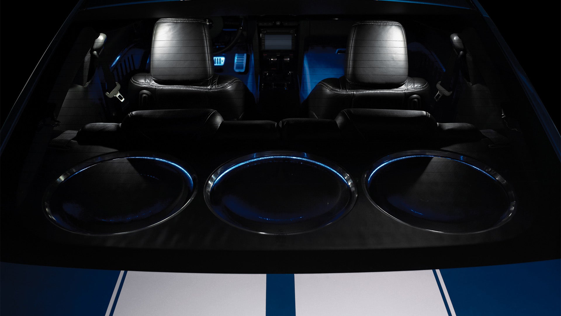A series of 3 TW5v2 car audio subwoofer units installed in the back of a vehicle.