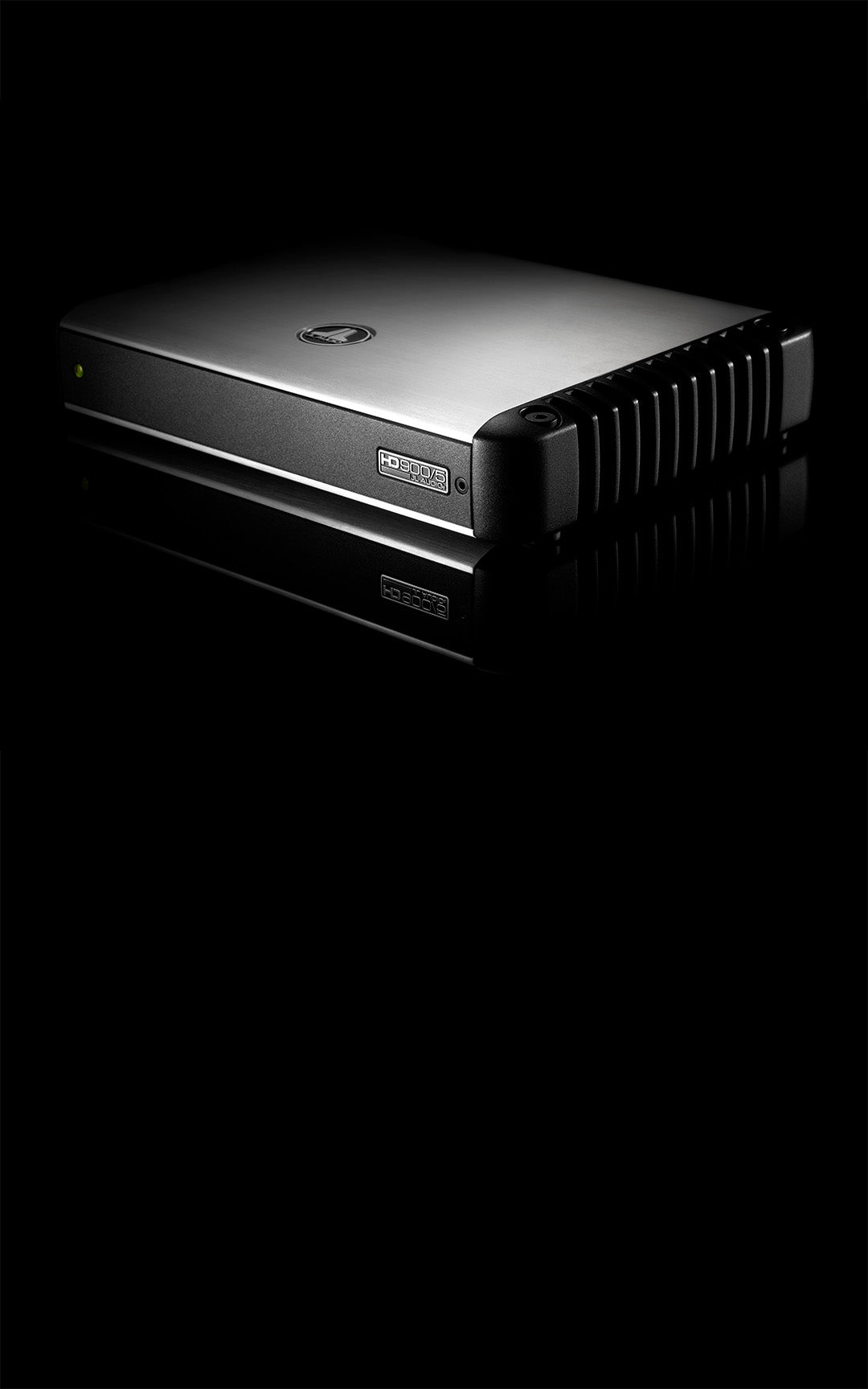 An angled view of an HD900 amplifier in a dark sleek setting.