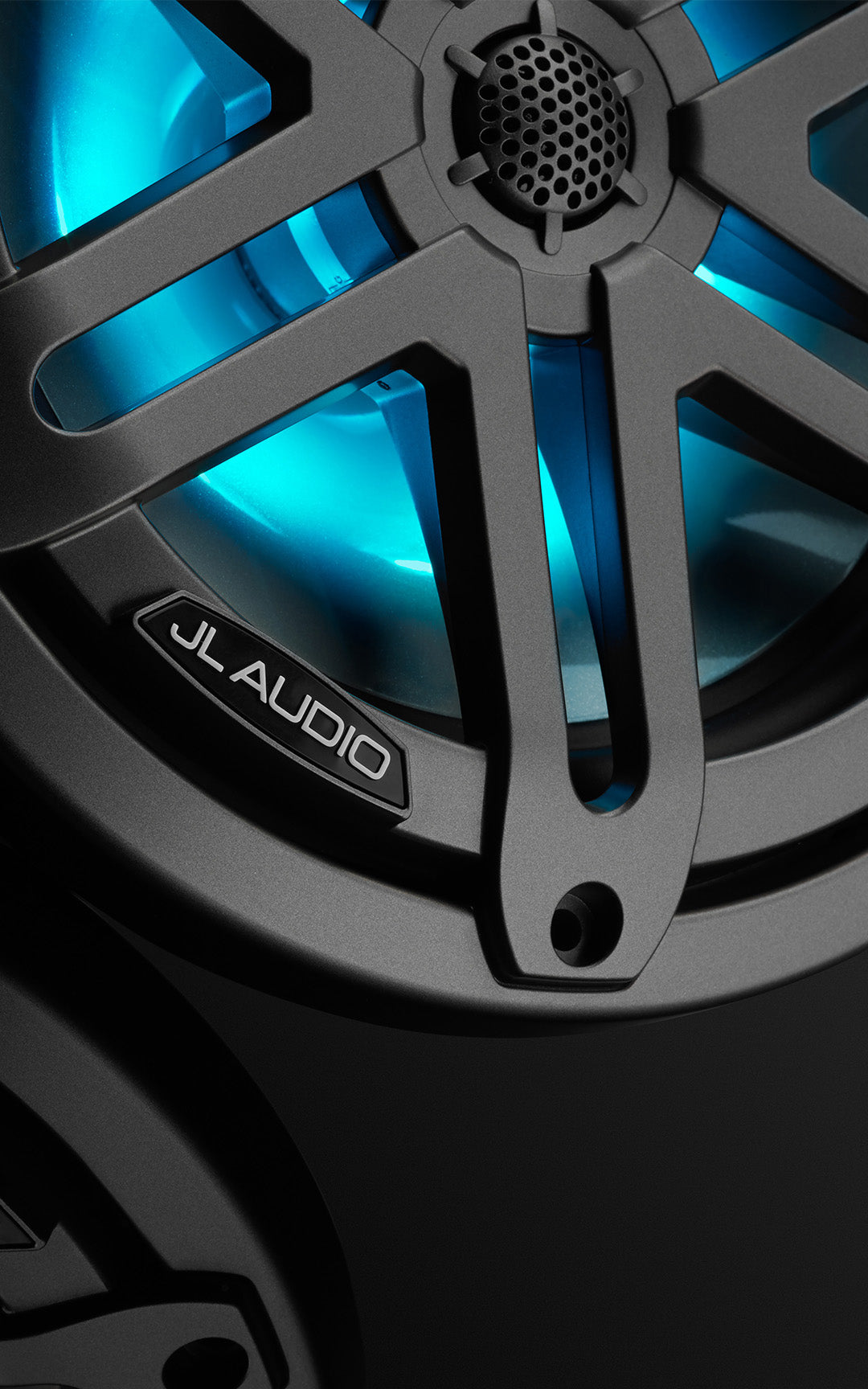 An M3 7.7 inch speaker in gunmetal with blue RGB LED lights in a dark sleek setting.
