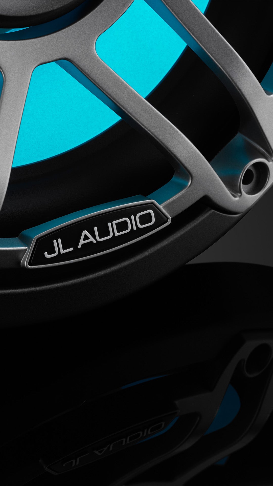 A closeup view of a M6 8.8 inch subwoofer with gunmetal finish and light blue Transflective RGB Technology.