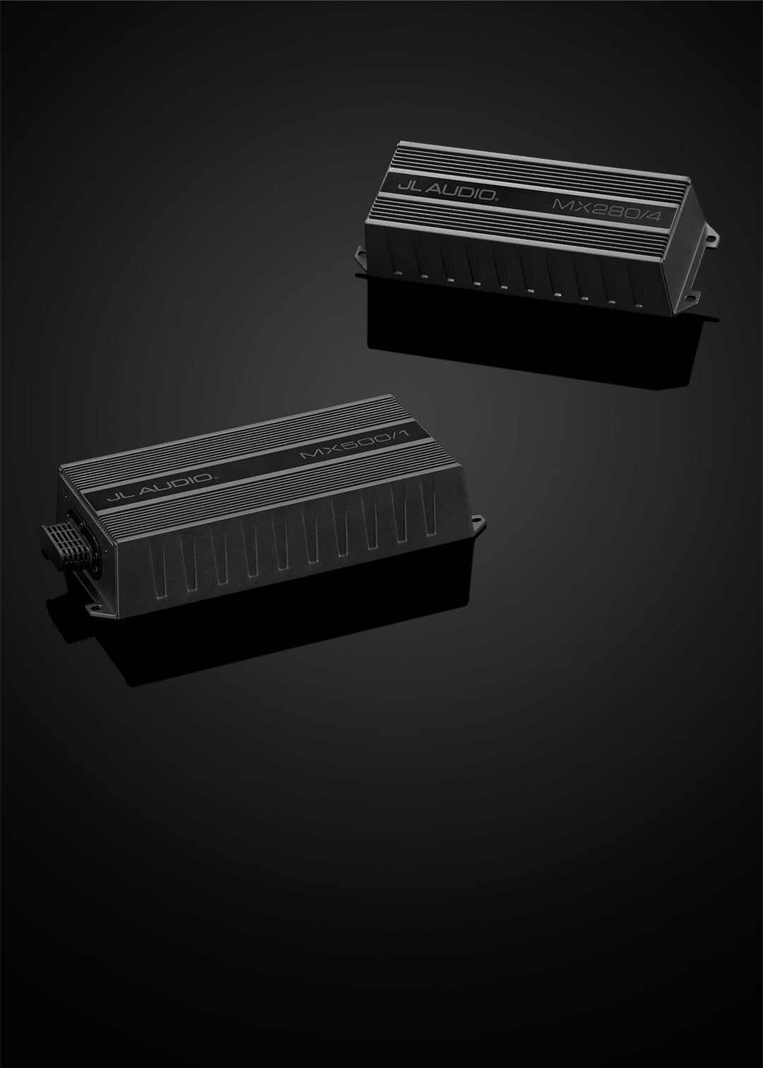 A pair of MX amplifiers in a dark sleek setting.