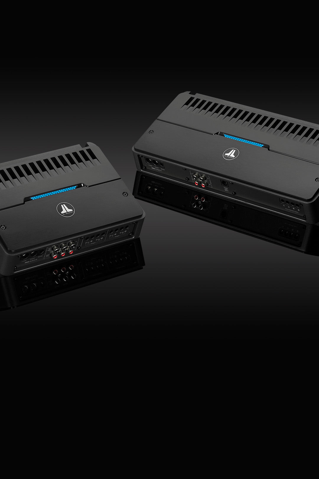 A pair of RD amplifiers on a sleek black surface.