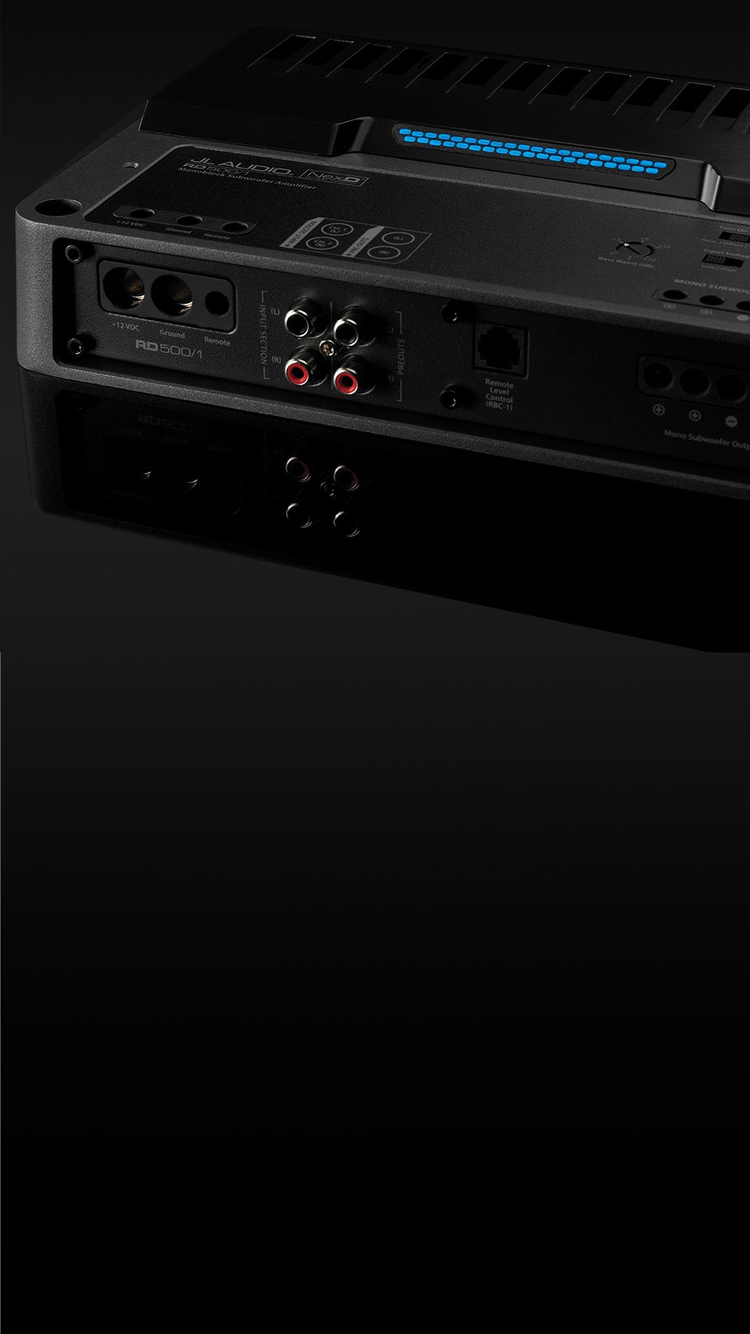 A closeup view of the input panel of an RD amplifier with the top uncovered, in a dark sleek surface. 