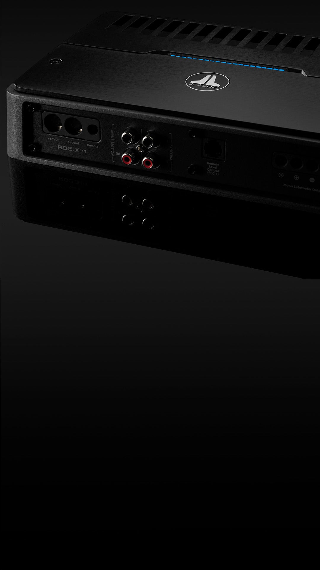 A closeup view of the input panel of an RD amplifier with the top cover on, in a dark sleek surface. 