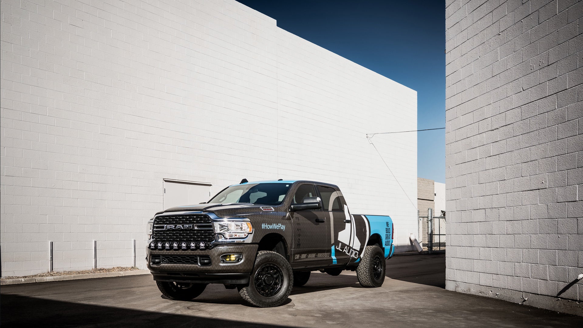 Dodge Ram truck parked between 2 buildings