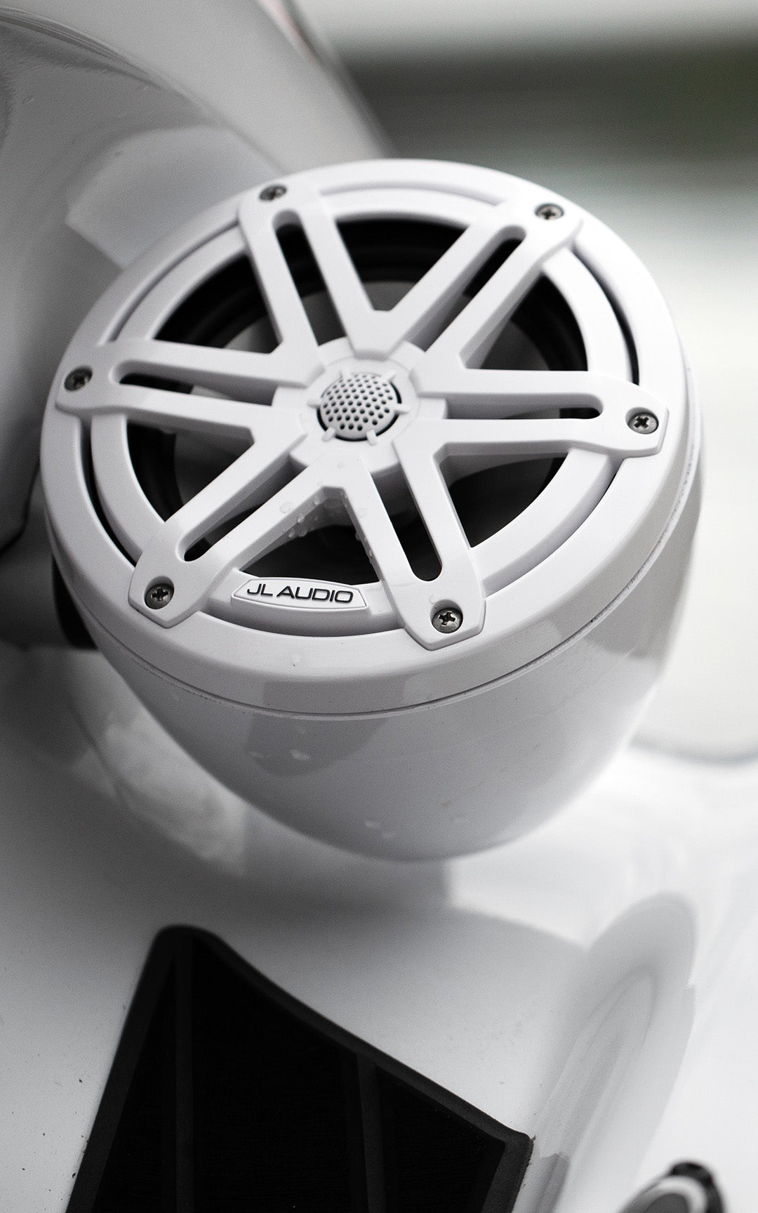 A closeup view of a white VeX Speaker unit installed on a jet ski.