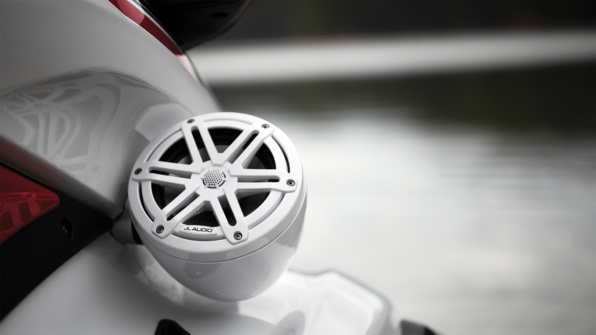 A closeup view of a white VeX Speaker unit installed on a jet ski.