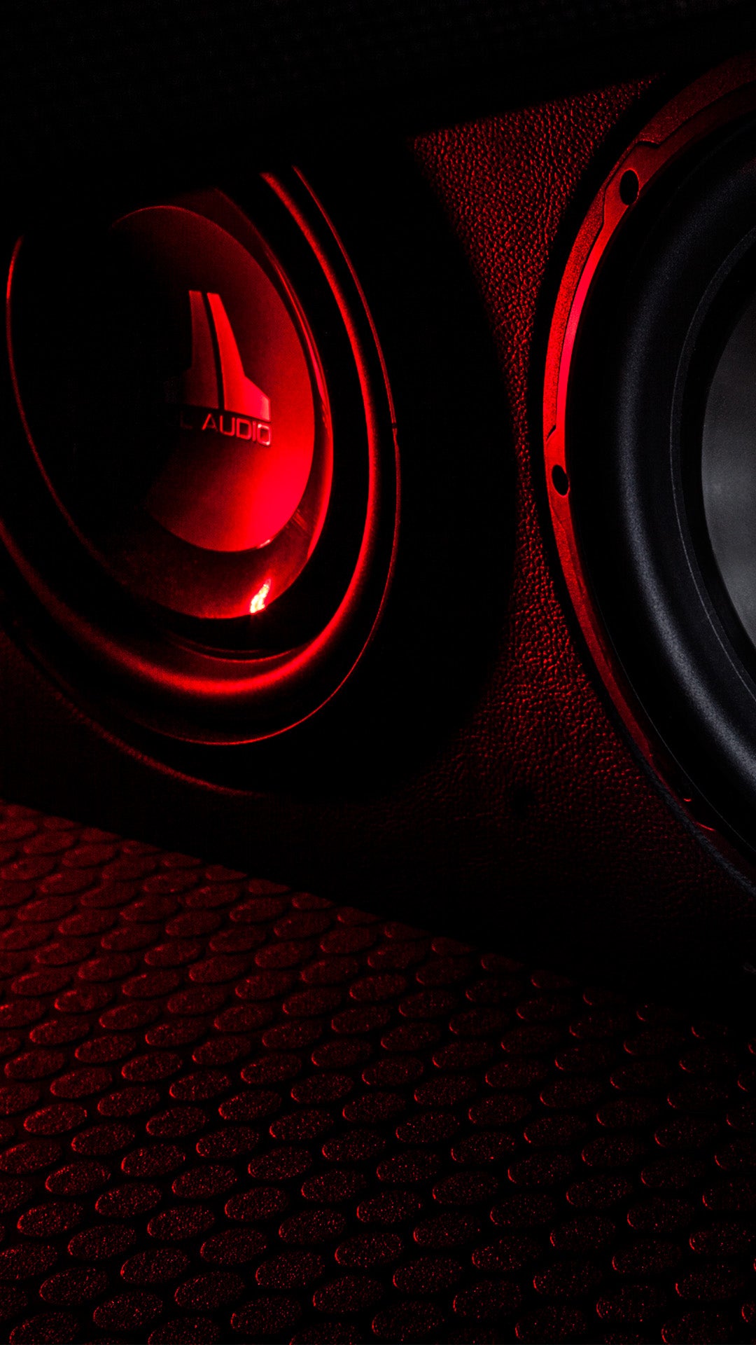 A pair of W1v3 subwoofer units in a truck with red LED lighting.