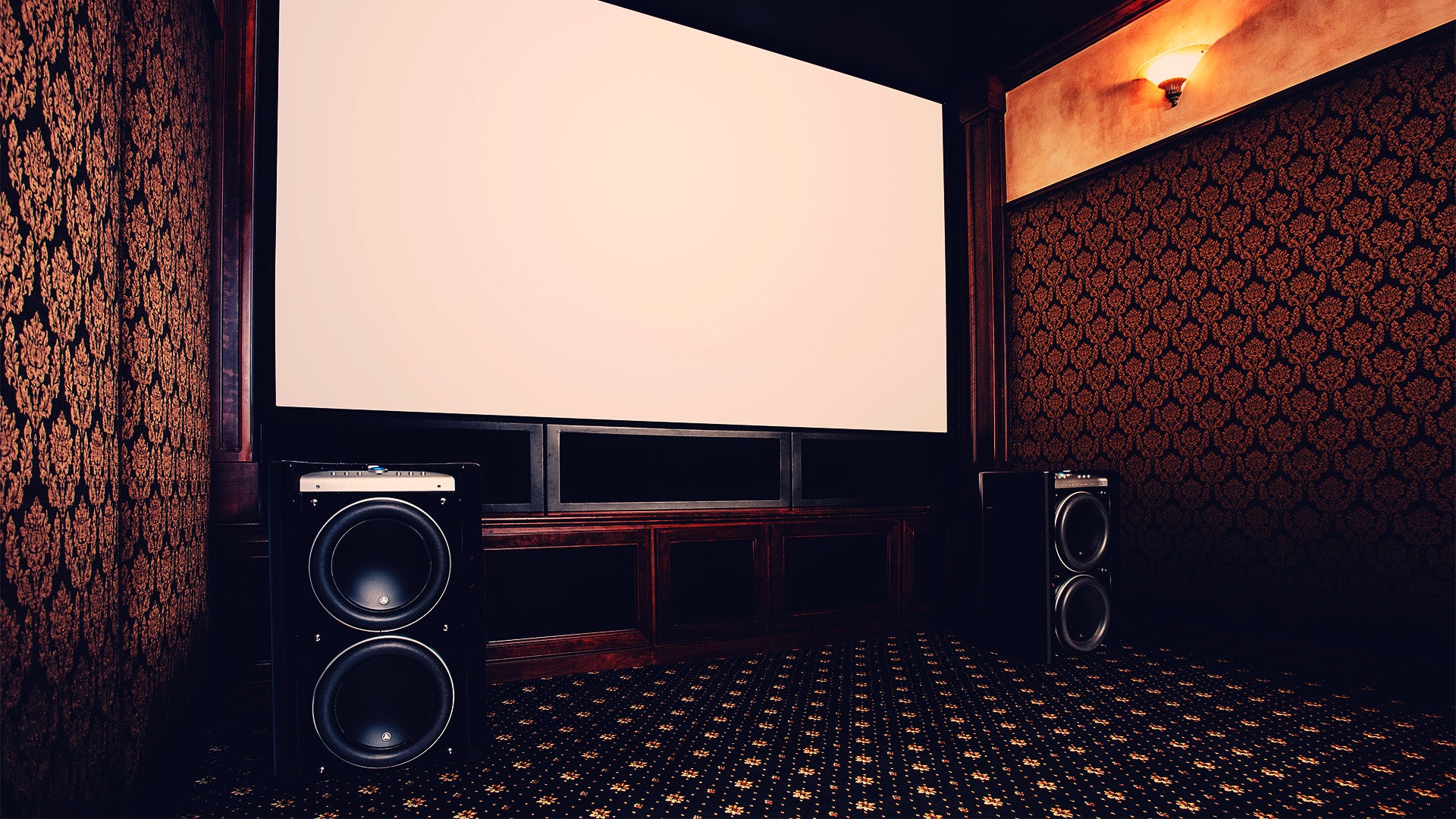 A pair of Gotham v2 subwoofers placed in a home theatre room.