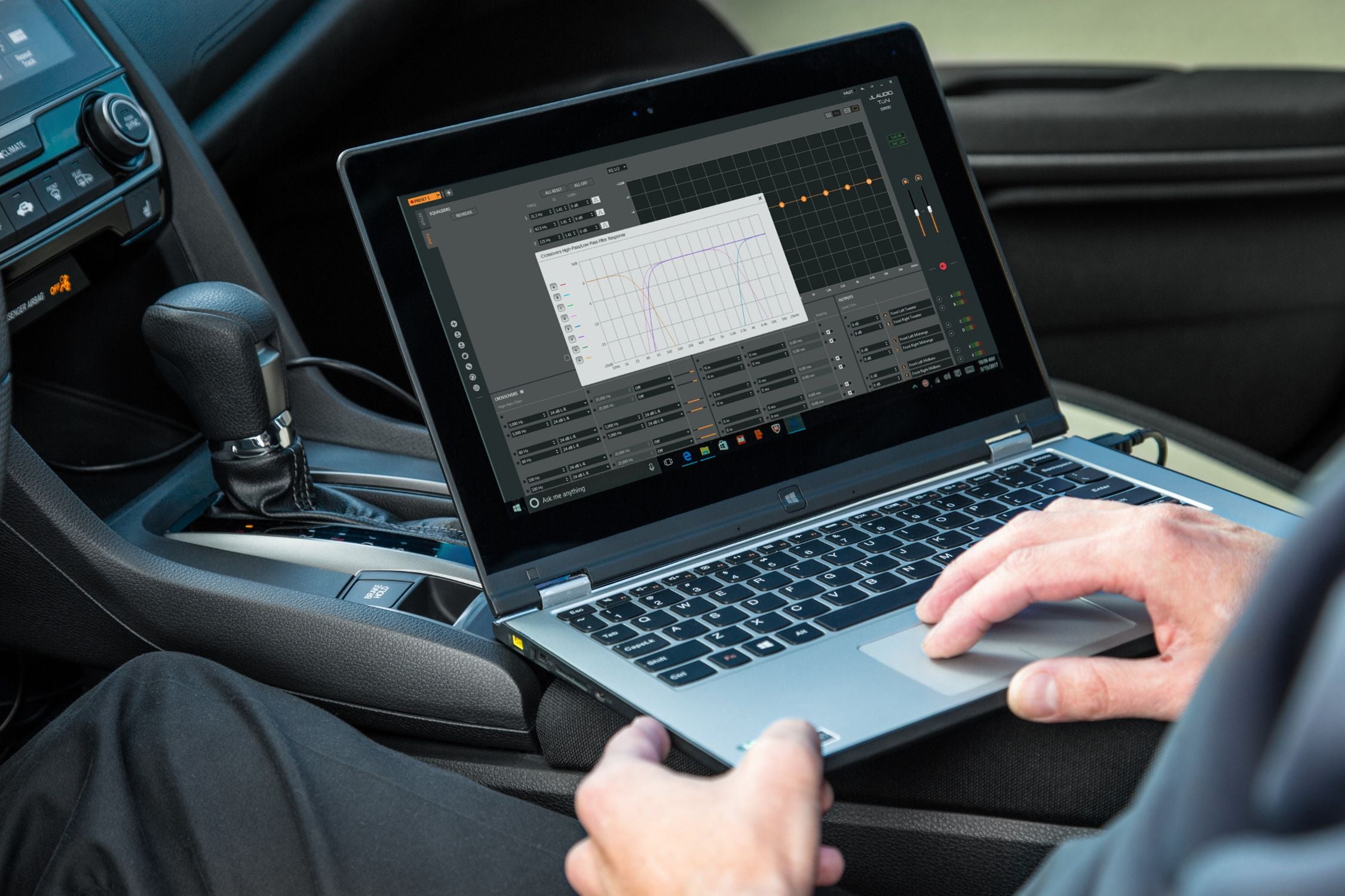 Hand on a Laptop Setting a Crossover with TüN Software in a Honda